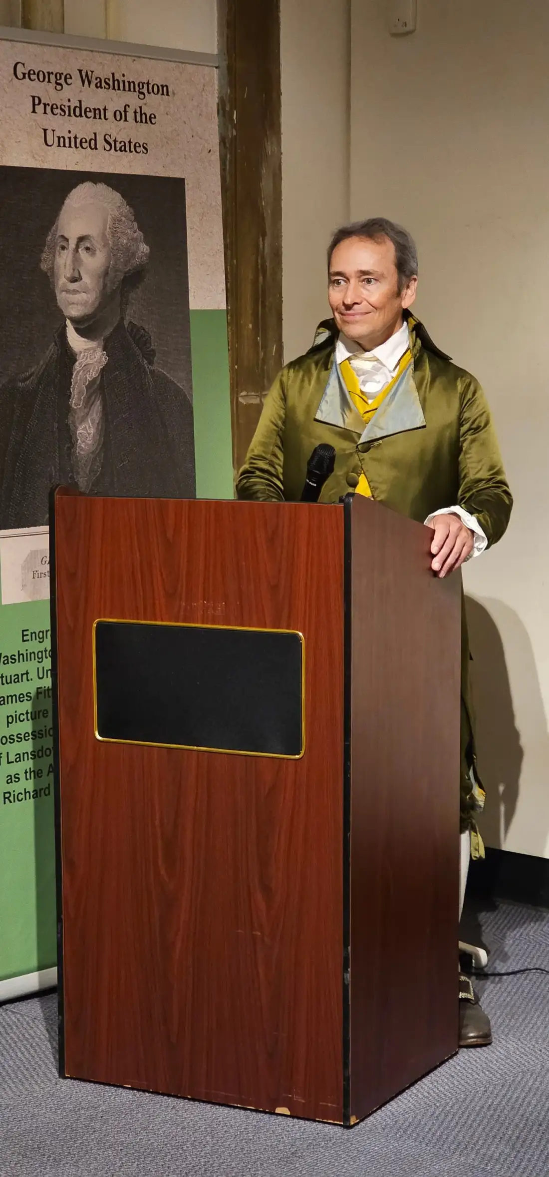 Scott MacScott delivering a keynote speech at a podium